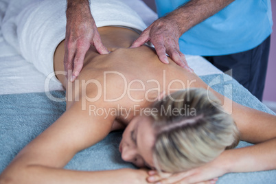 Woman receiving back massage from physiotherapist