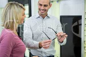 Optician helping customer for selecting a spectacles frame