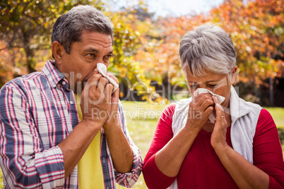 An elderly couple giving a blow