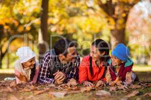 Happy family lying on field at park