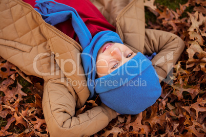 High angle view of boy lying at park during autumn