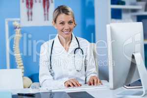 Physiotherapist working on computer