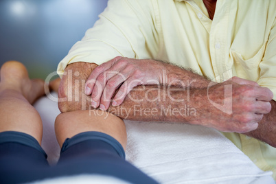 Physiotherapist giving leg massage to a woman