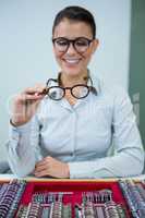 Optician looking at spectacles