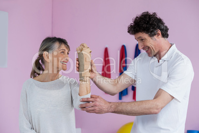 Physiotherapist examining a senior womans wrist