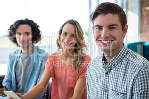 Portrait of three friends sitting in coffee shop