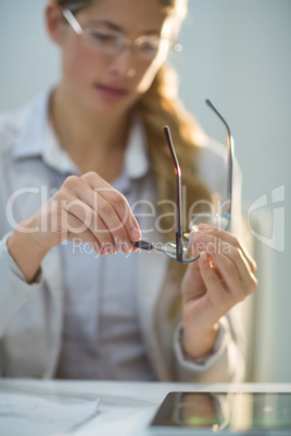 Female optometrist preparing glass frame