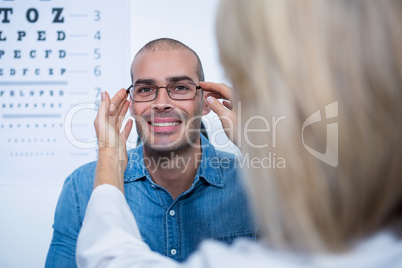 Female optometrist prescribing spectacles to patient