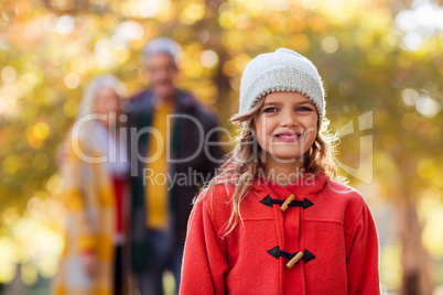 Portrait of smiling girl with family in background