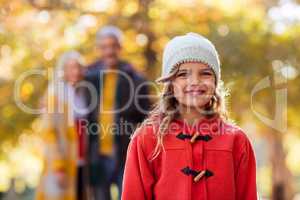 Portrait of smiling girl with family in background