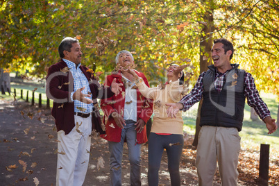 Family enjoying with autumn leaves