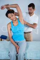 Physiotherapist examining womans back