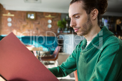 Man looking at menu
