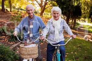 Senior couple riding their bike