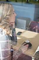 Woman having coffee in cafeteria