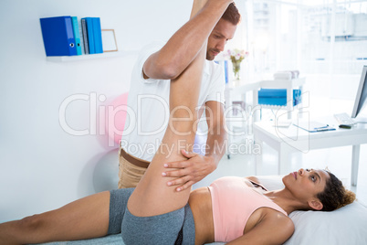 Physiotherapist giving leg massage to a woman