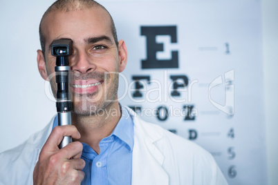 Optometrist looking through ophthalmoscope