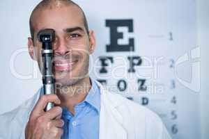 Optometrist looking through ophthalmoscope