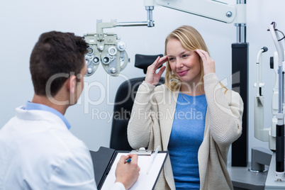 Optometrist consulting female patient