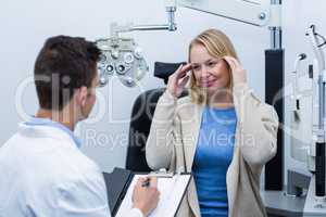 Optometrist consulting female patient