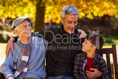 Happy man with father and son at park