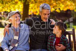 Happy man with father and son at park