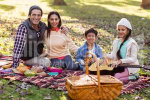 Portrait of family relaxing at park