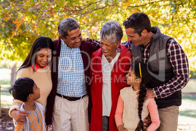 Cheerful multi-generation family standing at park