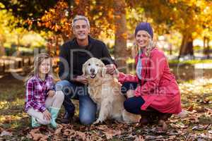 Happy parents with daughter and dog at park