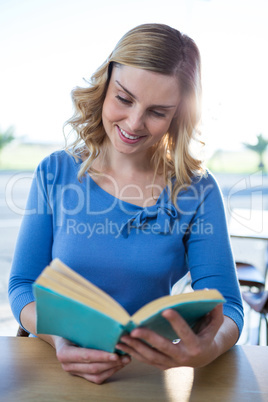 Woman reading a novel in the coffee shop