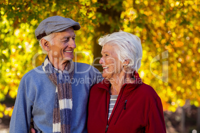 Happy senior couple looking at each other in park during autumn