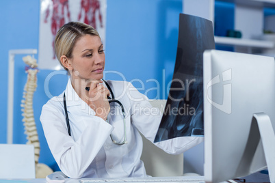 Physiotherapist looking at a x-ray