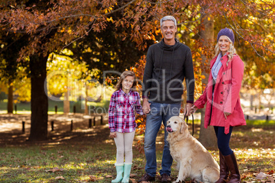 Happy family with dog at park