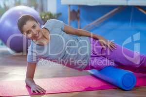 Woman performing exercise using foam roll