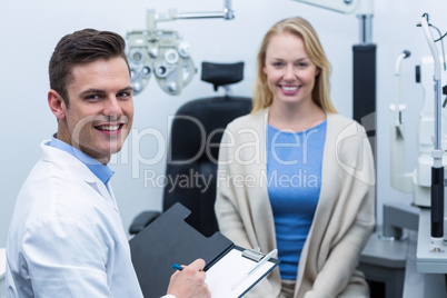 Optometrist consulting female patient