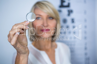 Female patient looking through magnifying glass