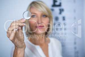 Female patient looking through magnifying glass