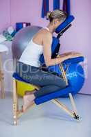 Woman sitting on massage chair