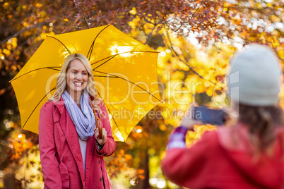 Girl photographing mother at park