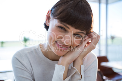 Close-up of smiling woman in cafeteria