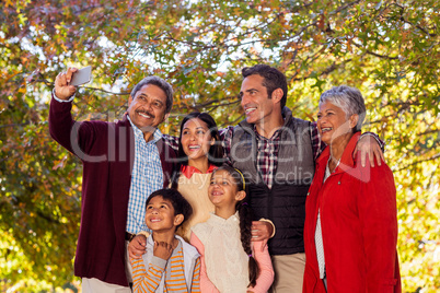 Multi-generation family taking selfie at park