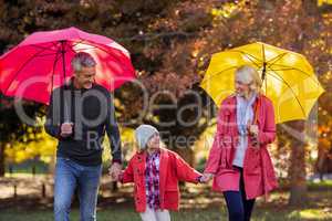 Cheerful parents with daughter at park