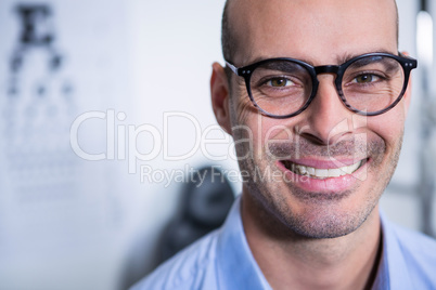 Optometrist wearing spectacles in ophthalmology clinic