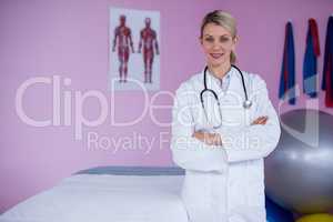 Portrait of physiotherapist standing with arms crossed