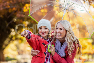 Cheerful girl with mother at park