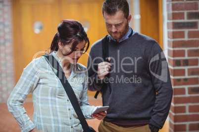 Mature students discussing over mobile phone