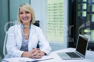 Female optometrist sitting in ophthalmology clinic