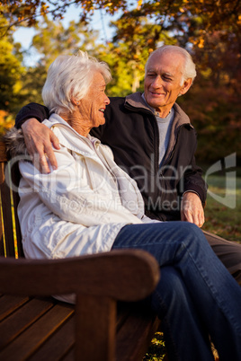 Senior couple embracing on a bencha