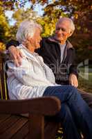 Senior couple embracing on a bencha