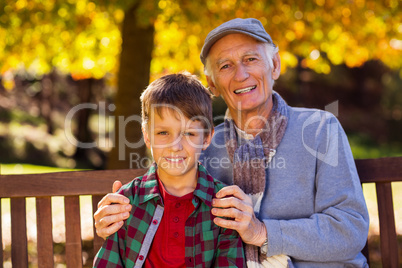 Grandfather sitting with grandson at park